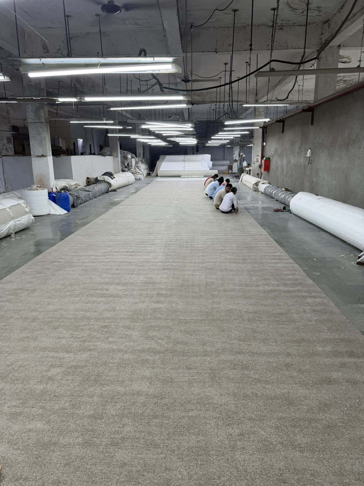Broadloom carpet roll under inspection on the factory floor