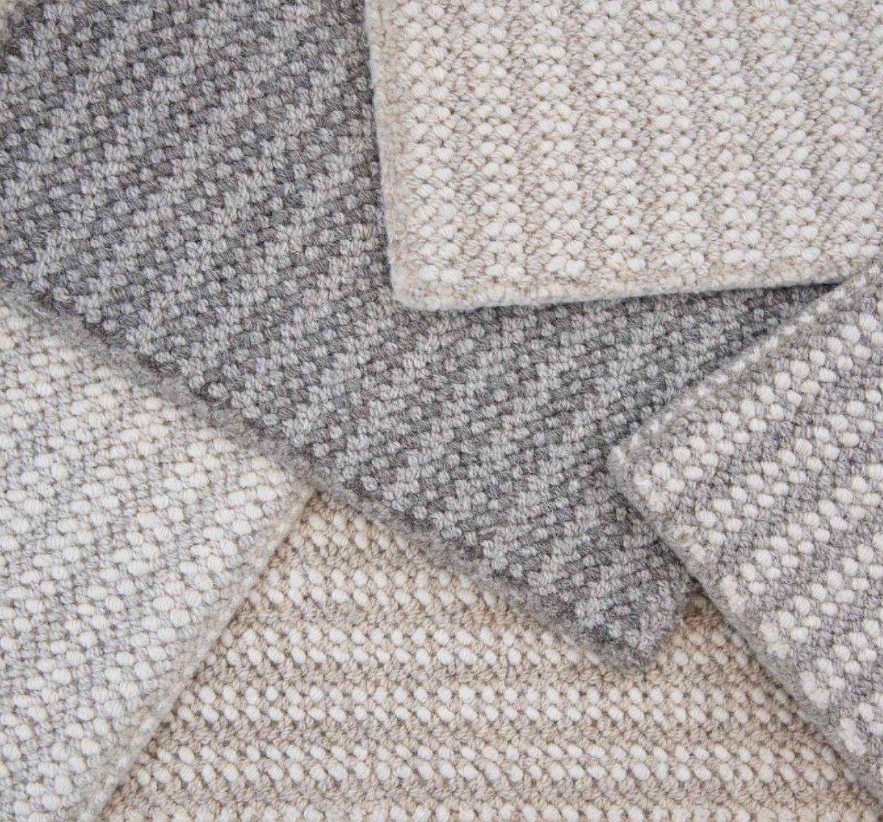 Finished handwoven wool rugs in layered grey and cream textures